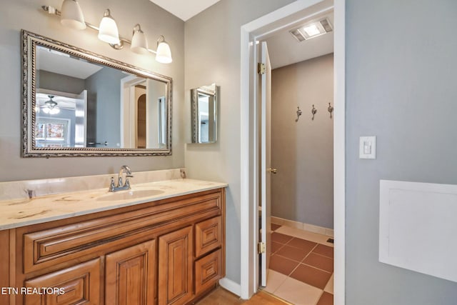 bathroom featuring tile patterned flooring, ceiling fan, and vanity