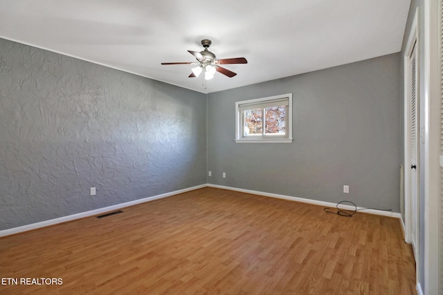 unfurnished room featuring ceiling fan and light hardwood / wood-style flooring