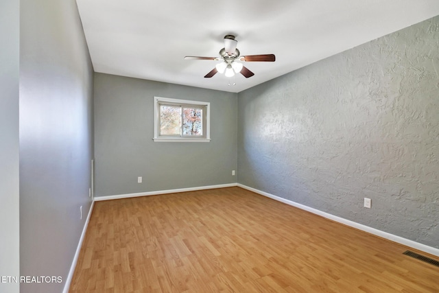 spare room with ceiling fan and light hardwood / wood-style flooring