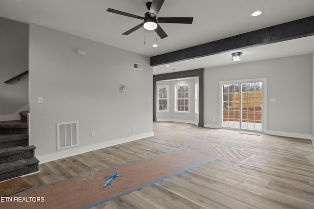 unfurnished living room with visible vents, recessed lighting, stairway, and light wood-style floors