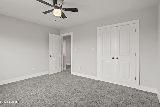 unfurnished bedroom featuring a closet, carpet flooring, a ceiling fan, and baseboards