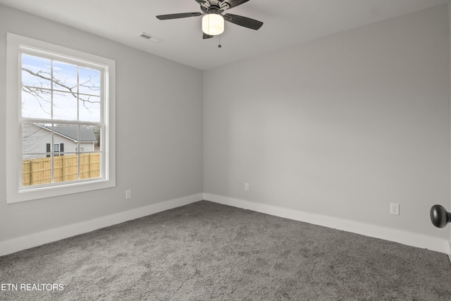 spare room with baseboards, carpet, visible vents, and ceiling fan