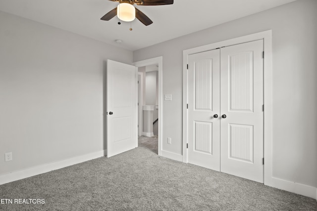 unfurnished bedroom featuring ceiling fan, carpet, a closet, and baseboards