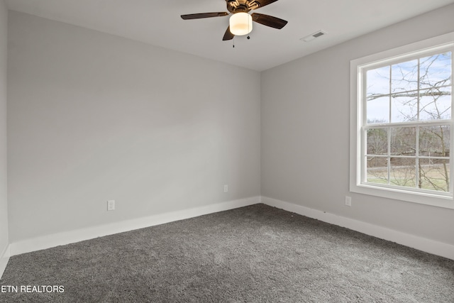 carpeted empty room featuring visible vents, ceiling fan, and baseboards