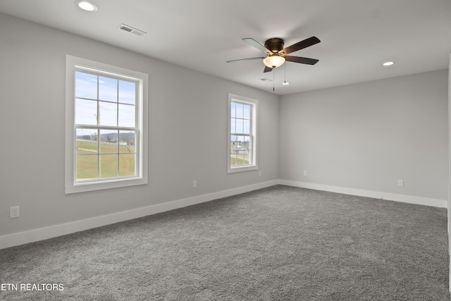 carpeted empty room with recessed lighting, visible vents, and baseboards