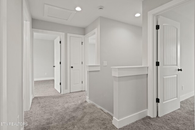 corridor with attic access, recessed lighting, carpet, and baseboards