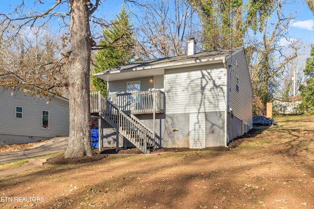 back of house featuring a deck