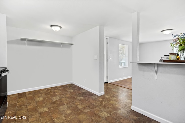 interior space with stone finish flooring and baseboards