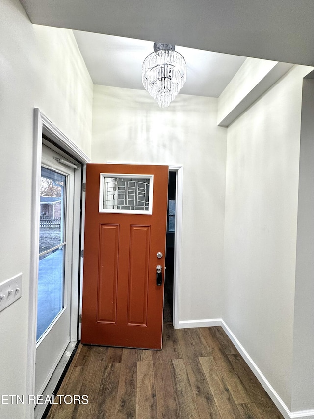 entryway featuring dark hardwood / wood-style floors and an inviting chandelier