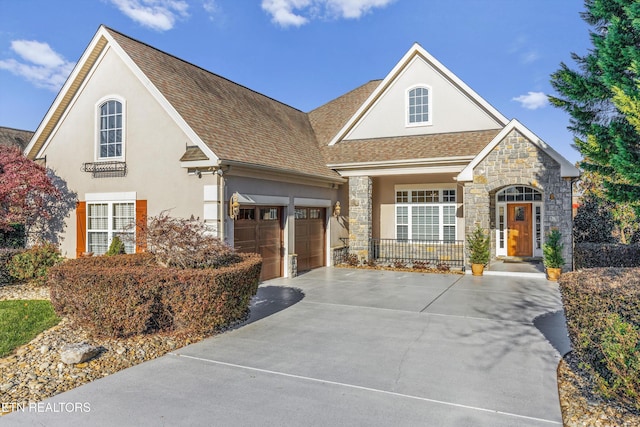 241 Goldcrest Dr, Vonore, TN 37885 - view of front of home featuring a garage, stone siding, and stucco siding