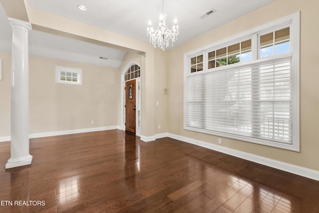 unfurnished room with decorative columns, dark wood-type flooring, and a healthy amount of sunlight