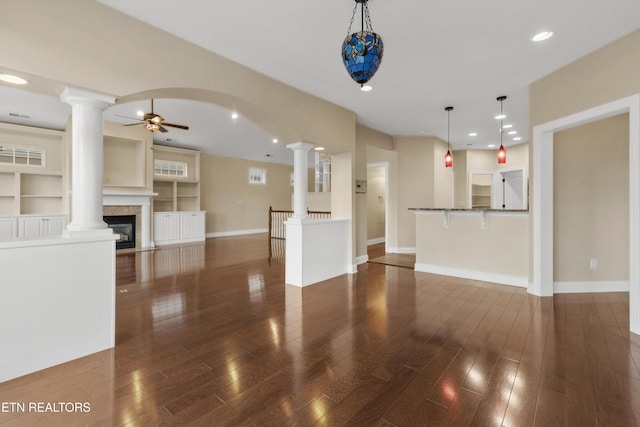 unfurnished living room with dark hardwood / wood-style floors and ceiling fan