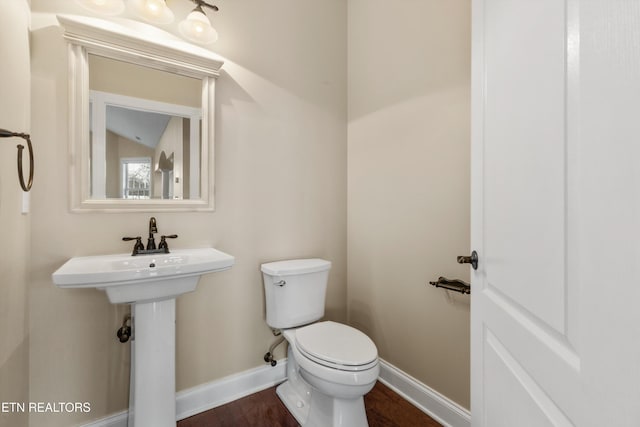 bathroom featuring toilet, wood-type flooring, and vaulted ceiling