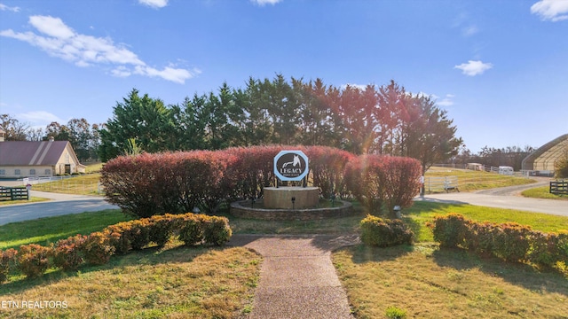 community / neighborhood sign with a lawn