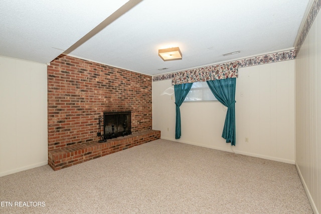 unfurnished living room featuring carpet flooring, a textured ceiling, and a fireplace