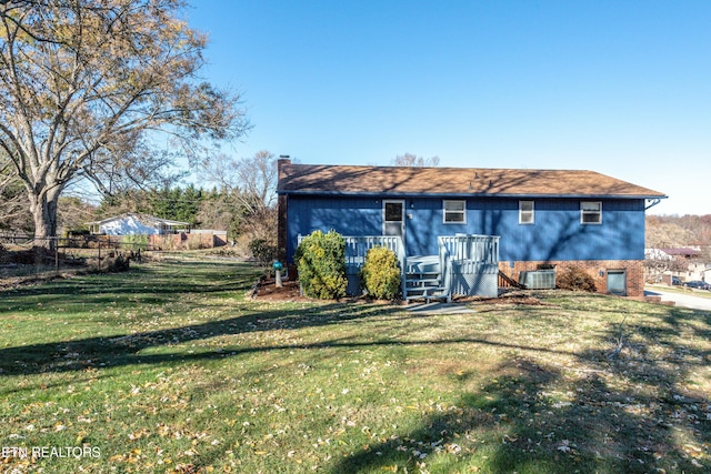 back of property featuring a wooden deck, a yard, and cooling unit