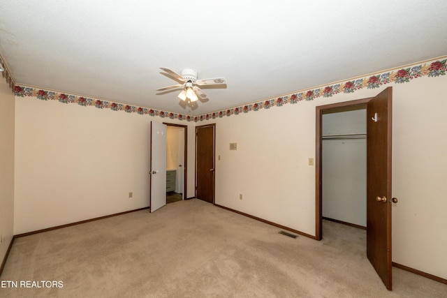 unfurnished bedroom with ceiling fan, a closet, and light colored carpet