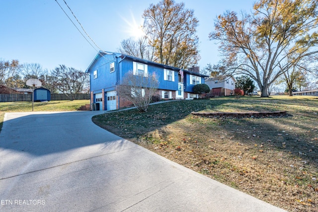 view of home's exterior with a garage and a yard