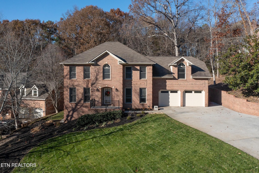 view of front of house with a garage and a front yard