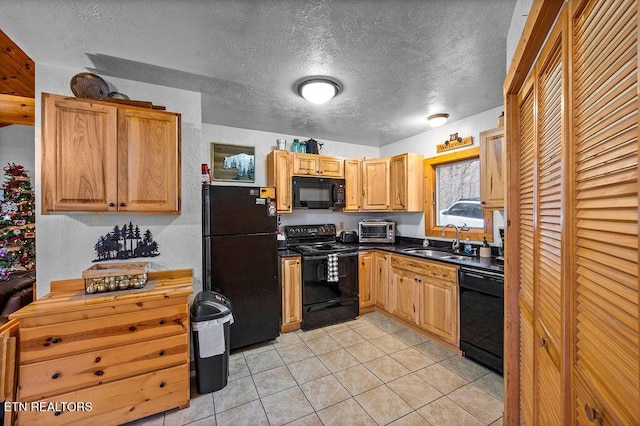 kitchen with a textured ceiling, sink, light tile patterned floors, and black appliances