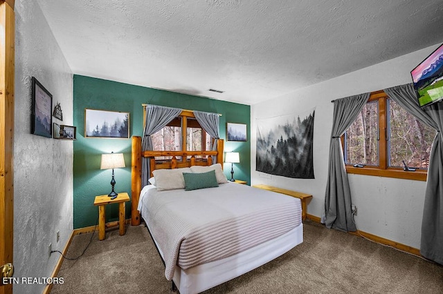 bedroom with carpet flooring and a textured ceiling