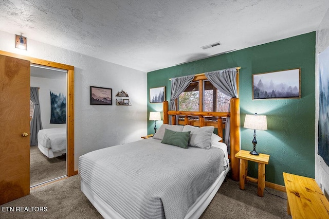 bedroom featuring a textured ceiling, carpet floors, and a closet