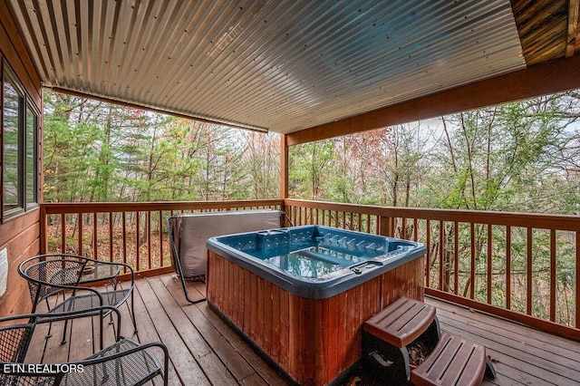 wooden terrace with a hot tub