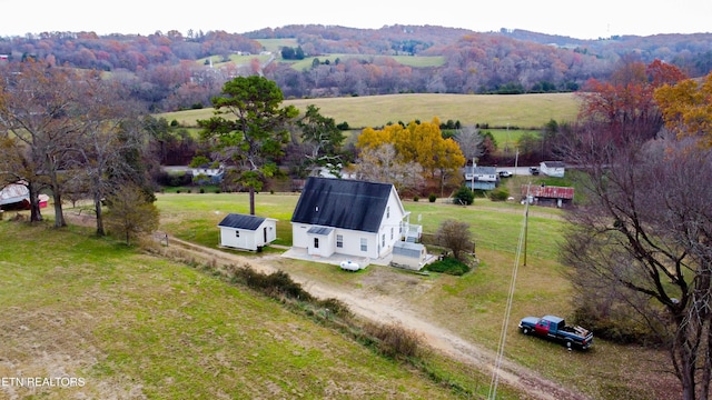 bird's eye view with a rural view and a view of trees