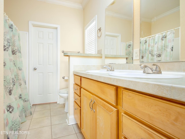 bathroom with tile patterned flooring, toilet, a sink, ornamental molding, and double vanity