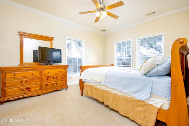 bedroom with visible vents, crown molding, and carpet flooring