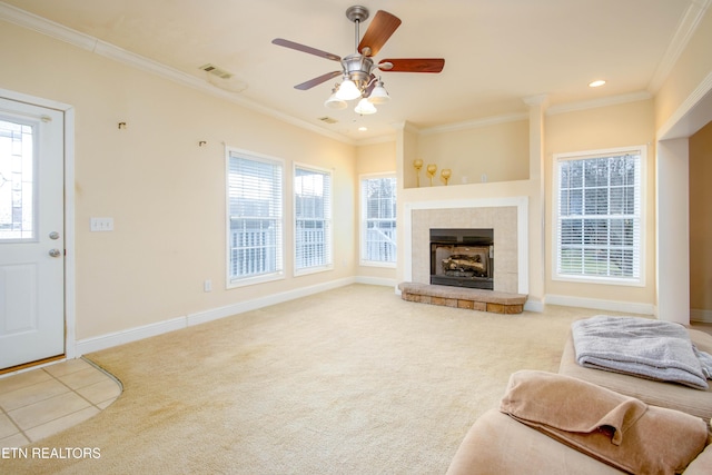 carpeted living area featuring ornamental molding, visible vents, a fireplace with raised hearth, and baseboards