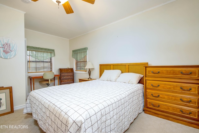 bedroom with a ceiling fan, light colored carpet, crown molding, and baseboards