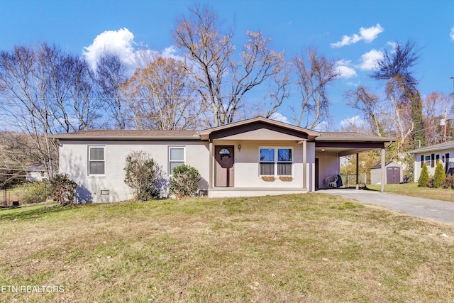 ranch-style house with a shed, a front yard, and a carport