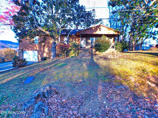 view of front of property featuring a garage and a front lawn