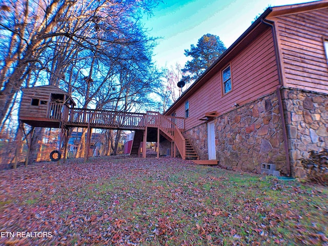 view of property exterior with a deck