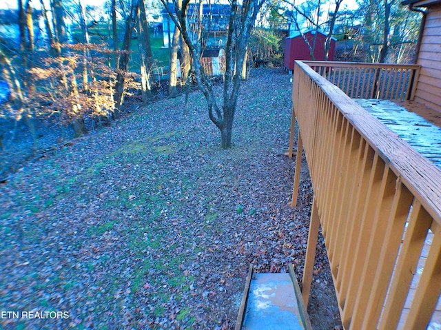 view of yard with a storage unit and a wooden deck