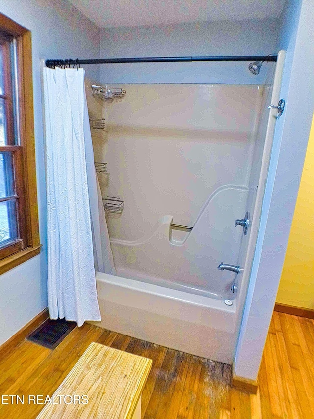 bathroom featuring hardwood / wood-style floors and shower / tub combo