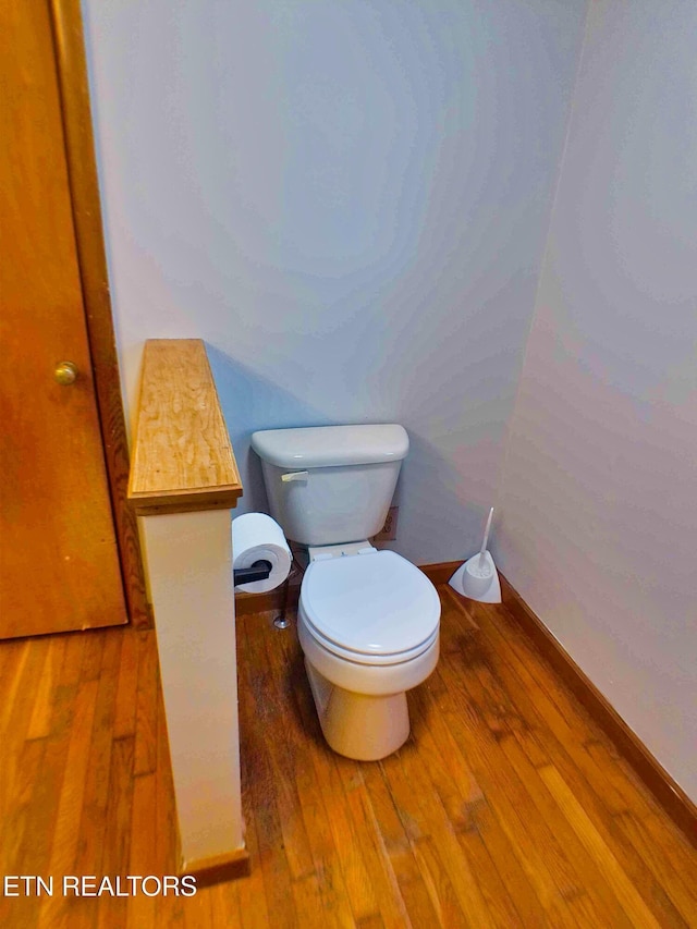 bathroom featuring hardwood / wood-style floors and toilet