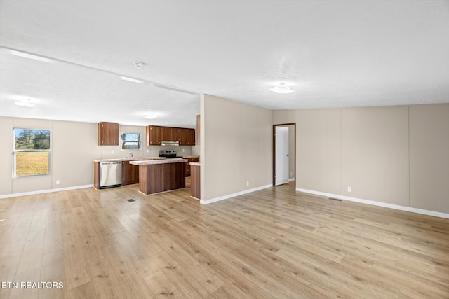 unfurnished living room with a textured ceiling and light hardwood / wood-style flooring