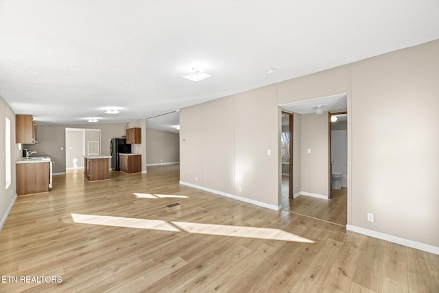 unfurnished living room featuring light wood-type flooring