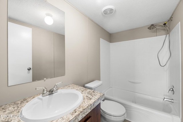 full bathroom featuring vanity,  shower combination, toilet, and a textured ceiling