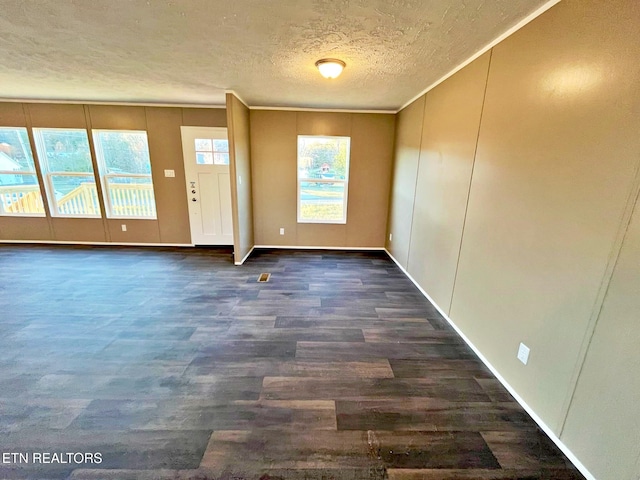 interior space featuring dark hardwood / wood-style floors and a textured ceiling