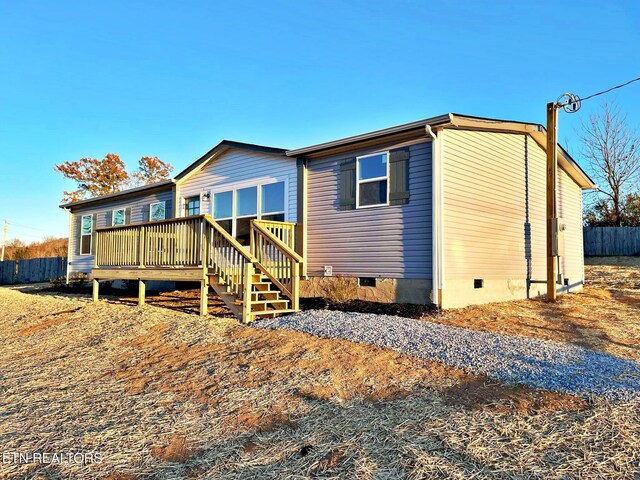 rear view of house with a wooden deck