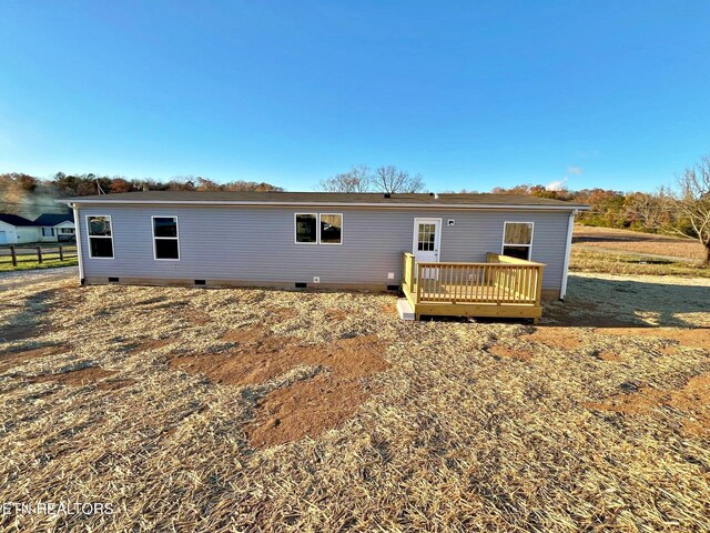 back of house with a wooden deck