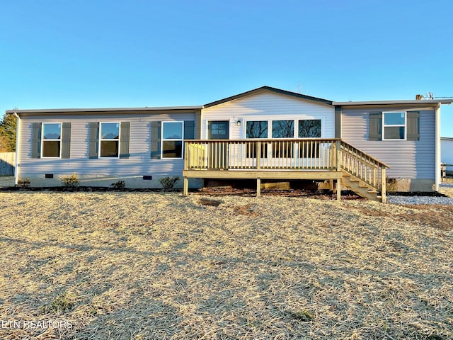 back of house featuring a deck