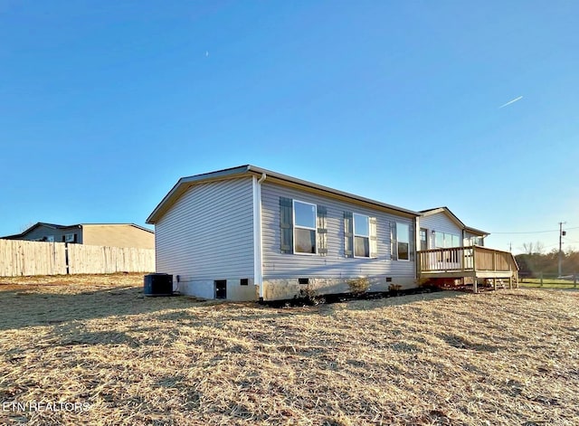 exterior space with a wooden deck and central AC