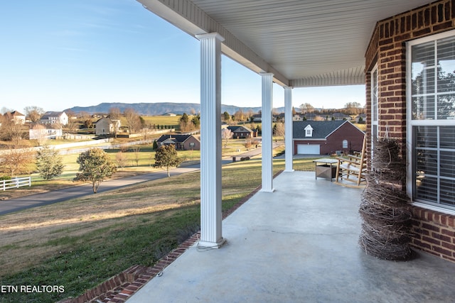 view of patio with a garage and a mountain view