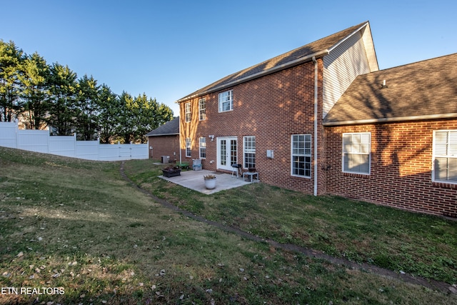 rear view of property with a patio area and a lawn