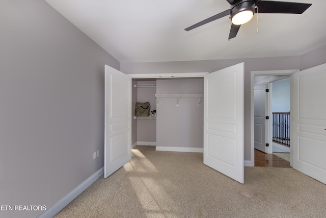 unfurnished bedroom with light carpet, ceiling fan, and a closet