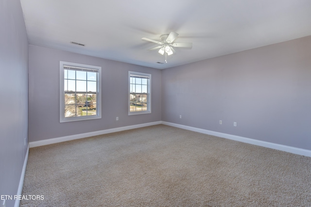 empty room featuring light carpet and ceiling fan